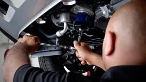 Kia tech tightening underneath vehicle