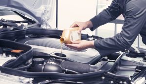 Technician changing oil in Kia