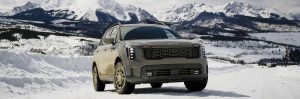 2025 Sorento standing on snow covered path with mountains in background